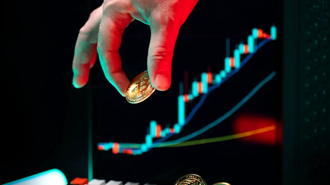 A hand reaching for a coin on a computer keyboard
