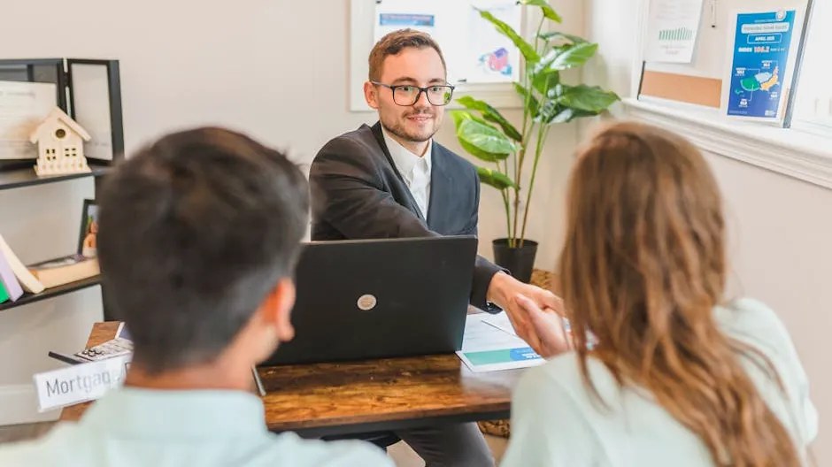 A mortgage broker meeting clients in an office, discussing agreements and loans.