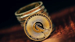 a stack of coins sitting on top of a wooden table