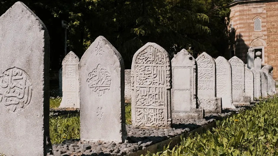 Intricately carved tombstones in Bursa's Ottoman cemetery with Arabic calligraphy.
