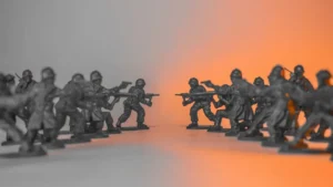 Toy soldiers in a standoff on a split background.