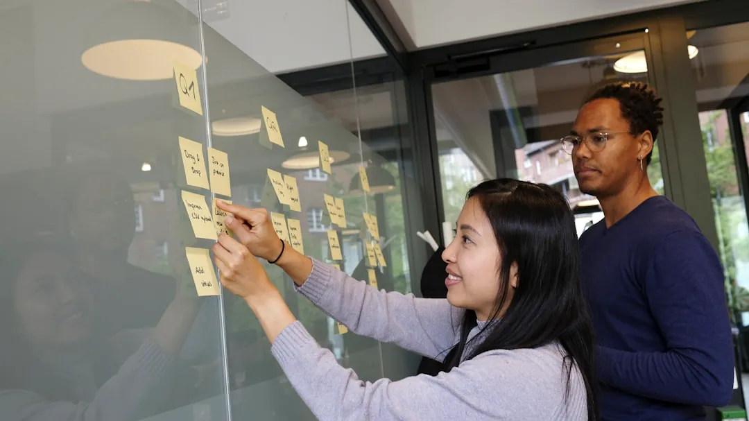 woman in gray sweater holding gold iphone 6