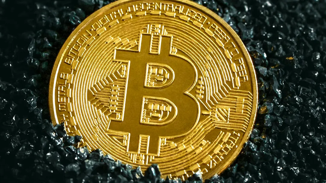 a bitcoin sitting on top of a black surface
