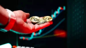 A person holding two gold coins in their hand