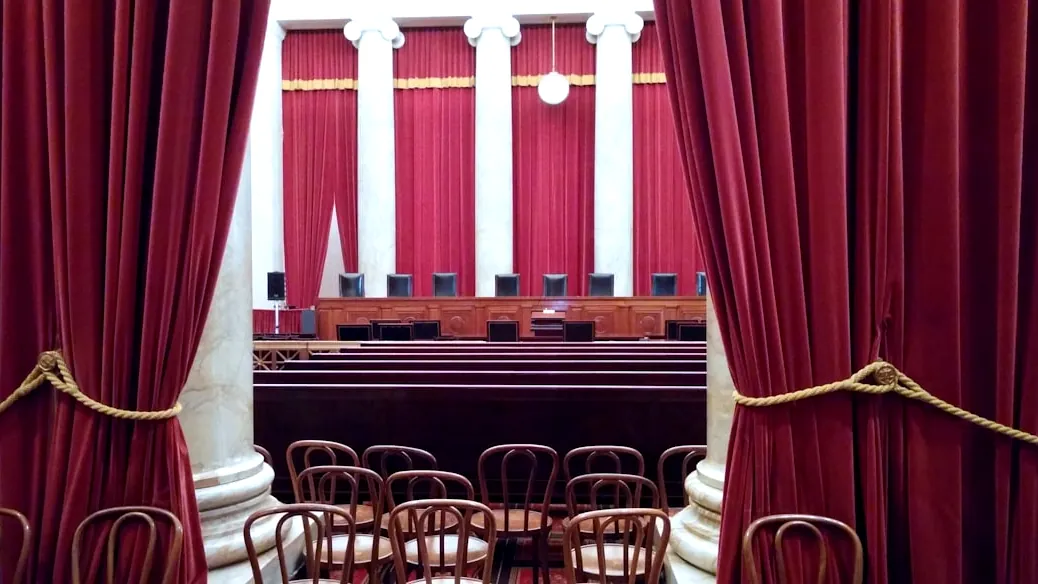 a room with red curtains and chairs in it
