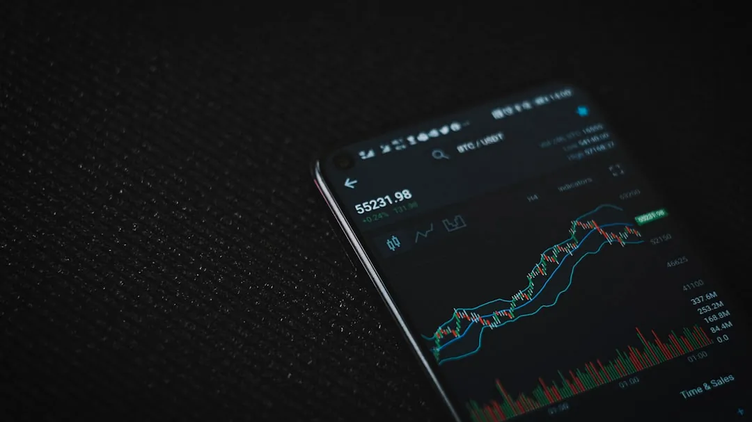 black android smartphone on black textile