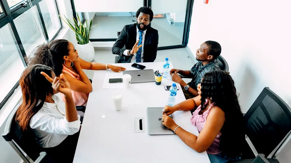 Business professionals engage in a collaborative meeting in a bright Lagos office.