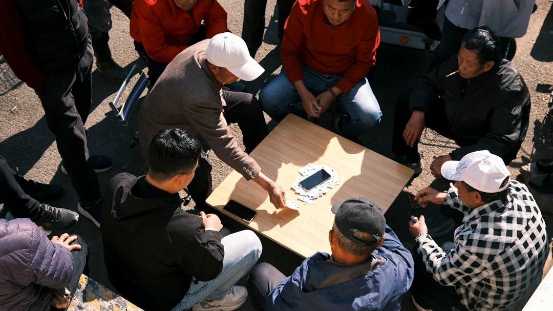 People play a game around a table.