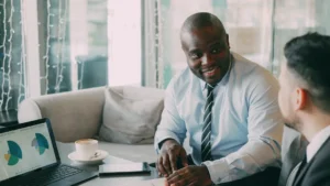 Two businessmen in a meeting with laptop and laptop.