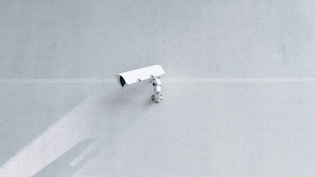 white box security camera on wall
