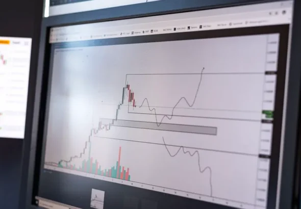 Close-up of stock market analysis charts on a monitor, showcasing market trends.